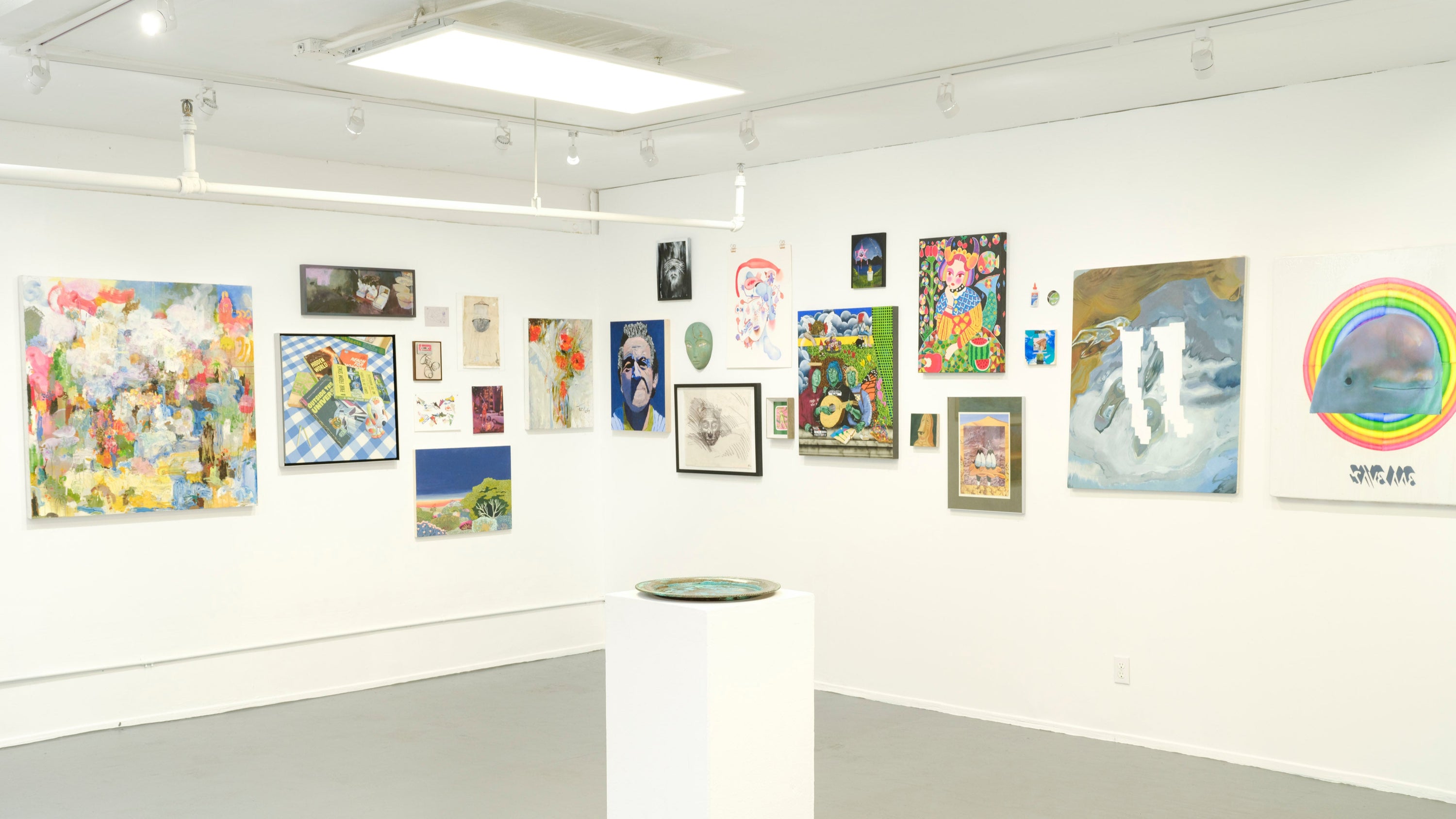 Art gallery with various artworks on the walls